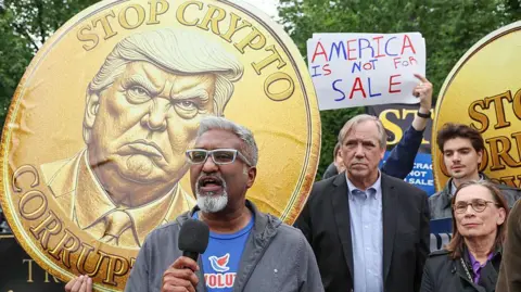 Getty Images Protestors bearing placards outside the event