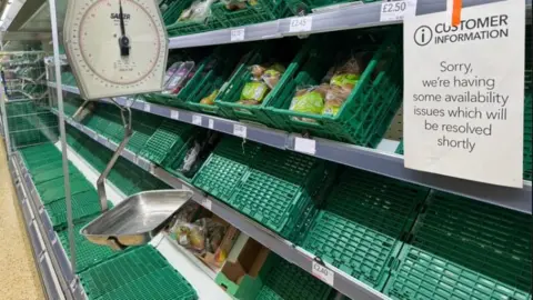 John Walker Empty shelves in a Co-op store