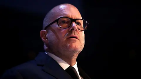 Getty Images Jony Ive in glasses presents the Fashion Icon award on stage during The Fashion Awards 2019 held at Royal Albert Hall on December 02, 2019 in London, England.