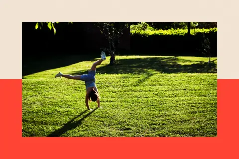 Universal Archive/Universal Images Group via Getty Images Girl playing in a garden
