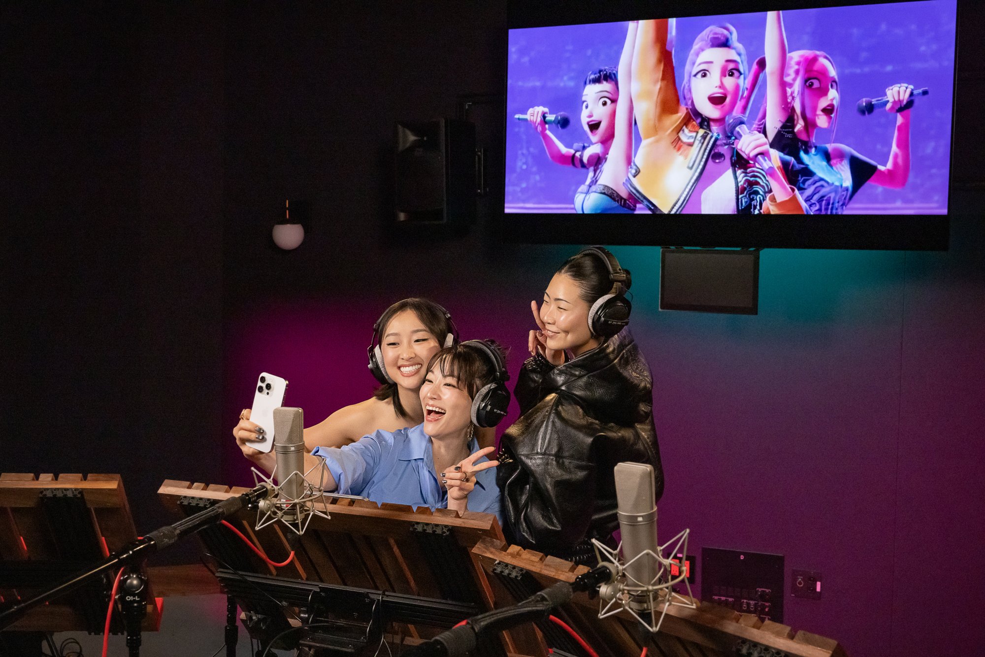 Arden, May, and Ji-young taking a selfie while recording "K-pop Demon Hunters."