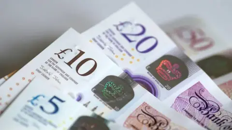 PA Media A photo of British £5, £10 and £20 notes