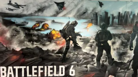 An impressionistic painting of two solders dressed in grey military gear climbing across a battlefield. There are military jets flying though the air, fire on the ground around them and there is a city in the distance across some water.