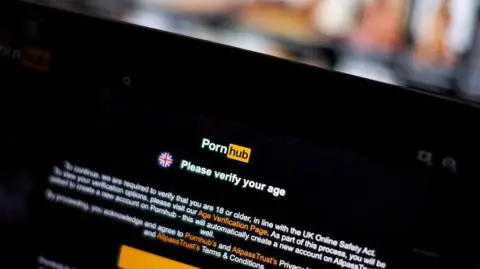 Getty Images A photograph of a computer screen showing the home page of pornhub with a notice obscuring most of the page which says "Please verify your age"