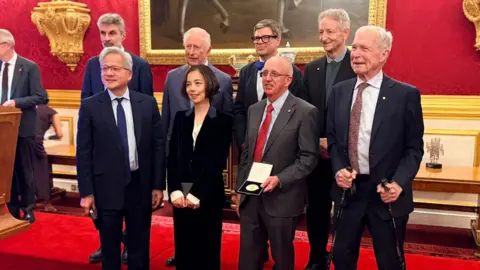 The seven key figures in AI who received an award from the King - back row left to right: Yoshua Bengio; the King; Yan LeCunn; Geoffrey Hinton and front row, left to right: Jensen Huang; Fei-Fei Li; Bill Dally; and John Hopfield 