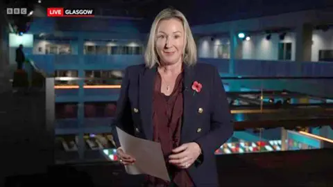 BBC BBC technology editor Zoe Kleinman holding notes as she speaks on the BBC News at Ten