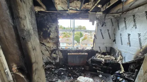 McConnell Family A burnt out room. Everything is black and charred.